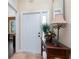 Welcoming foyer with a stylish table, decorated with flowers, and a beautiful mirror on the wall at 11343 Dancing River Dr, Venice, FL 34292