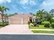 Charming home with a red tile roof, a paver driveway, and lush tropical landscaping at 11343 Dancing River Dr, Venice, FL 34292