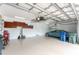 Spacious garage with storage cabinets, painted floor, ample lighting, and room for parking at 11343 Dancing River Dr, Venice, FL 34292