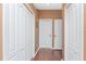 Hallway with hardwood floors and white doors at 11343 Dancing River Dr, Venice, FL 34292