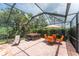 Relaxing screened in patio area features hot tub and outdoor seating at 11343 Dancing River Dr, Venice, FL 34292