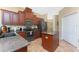 Well-equipped kitchen with granite countertops, stainless appliances, and a functional center island at 11343 Dancing River Dr, Venice, FL 34292