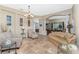 Spacious living room with tile flooring, neutral tones, and an open layout to the dining area at 11343 Dancing River Dr, Venice, FL 34292