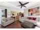 Spacious living room with dark wood floors, tray ceiling, comfortable seating, and open concept to kitchen at 11343 Dancing River Dr, Venice, FL 34292