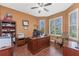 Inviting office space with hardwood floors, a ceiling fan, and large windows dressed with plantation shutters at 11343 Dancing River Dr, Venice, FL 34292