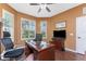 Comfortable office space with a large desk, hardwood floors, and large windows offering plenty of natural light at 11343 Dancing River Dr, Venice, FL 34292