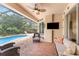 Relaxing screened patio area with outdoor seating and a view of the pool at 11343 Dancing River Dr, Venice, FL 34292