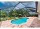 Outdoor screened-in pool with hot tub and a view of lush landscaping at 11343 Dancing River Dr, Venice, FL 34292