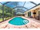 Beautiful screened in pool with hot tub and outdoor seating area at 11343 Dancing River Dr, Venice, FL 34292