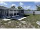 Backyard featuring a screened-in porch that lets in lots of light and a small patio at 1144 Rushmore Dr, Holiday, FL 34690