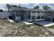 Spacious backyard featuring a screened-in porch and plenty of room for outdoor activities at 1144 Rushmore Dr, Holiday, FL 34690