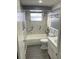 Updated bathroom with marble-look tile, a shower-tub combo, and modern fixtures at 1144 Rushmore Dr, Holiday, FL 34690