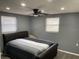 Neutral bedroom featuring a ceiling fan, recessed lighting, and stylish striped bedding at 1144 Rushmore Dr, Holiday, FL 34690