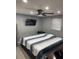 Relaxing bedroom with neutral walls, cozy bedding, ceiling fan, and a mounted TV at 1144 Rushmore Dr, Holiday, FL 34690