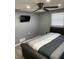 View of bedroom shows a modern mounted TV and a fan with integrated lighting at 1144 Rushmore Dr, Holiday, FL 34690