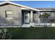 Close-up of home's front door with decorative details, landscaping, and exterior lighting at 1144 Rushmore Dr, Holiday, FL 34690