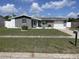 Charming single-story home featuring a manicured lawn and attached garage and mature landscaping at 1144 Rushmore Dr, Holiday, FL 34690