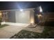 Single car garage, with driveway, featuring exterior lighting at 1144 Rushmore Dr, Holiday, FL 34690