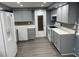Updated kitchen with gray cabinets, modern appliances, and stylish backsplash and countertops at 1144 Rushmore Dr, Holiday, FL 34690