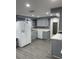Modern kitchen featuring stainless steel appliances, gray cabinets, and updated countertops at 1144 Rushmore Dr, Holiday, FL 34690