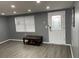 Comfortable living room with natural light from a large window and modern gray flooring at 1144 Rushmore Dr, Holiday, FL 34690