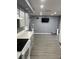 Open concept living room featuring hardwood floors seamlessly connected to kitchen at 1144 Rushmore Dr, Holiday, FL 34690