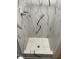 Beautiful marble shower with modern fixtures and mosaic tiled floor at 1144 Rushmore Dr, Holiday, FL 34690