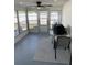 The bright sunroom has a ceiling fan and views of the backyard at 1144 Rushmore Dr, Holiday, FL 34690