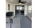 A bright sunroom is shown with backyard views and contemporary decor at 1144 Rushmore Dr, Holiday, FL 34690