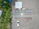 Aerial view of roof and property showing house, shed and vehicle at 11907 Frontage Rd, Dade City, FL 33525