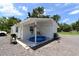 Exterior view of home features an open patio area and gravel backyard at 11907 Frontage Rd, Dade City, FL 33525