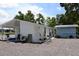 Exterior view of home features a shed and patio at 11907 Frontage Rd, Dade City, FL 33525