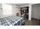 Cozy bedroom with neutral walls, wood-look floors and a view to the closet at 11907 Frontage Rd, Dade City, FL 33525