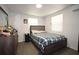 Cozy bedroom with neutral walls, wood-look floors and a comfortable bed at 11907 Frontage Rd, Dade City, FL 33525