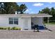 Image shows the exterior of the house with a small pool and sitting area at 11907 Frontage Rd, Dade City, FL 33525
