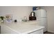 Kitchen area with modern white counters and a white refrigerator at 11907 Frontage Rd, Dade City, FL 33525