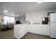 Well-lit kitchen with white countertops and modern appliances at 11907 Frontage Rd, Dade City, FL 33525