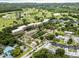 Aerial view of a community highlighting a golf course and a nearby water feature at 1250 S Pinellas Ave # 207, Tarpon Springs, FL 34689