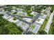 Aerial view of apartments with a pool, parking, landscaping, and mature trees surrounding the complex at 1250 S Pinellas Ave # 207, Tarpon Springs, FL 34689