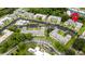 Aerial view of the community featuring the pool and complex surrounded by trees and lush grounds at 1250 S Pinellas Ave # 207, Tarpon Springs, FL 34689