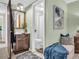 Well lit bathroom with a light green wall, wooden vanity, and blue accents at 1250 S Pinellas Ave # 207, Tarpon Springs, FL 34689