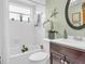 Well-lit bathroom featuring a tub, vanity, and decorative accents at 1250 S Pinellas Ave # 207, Tarpon Springs, FL 34689