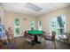 Cozy card room featuring natural light, game table with chairs, and space for recreation at 1250 S Pinellas Ave # 207, Tarpon Springs, FL 34689