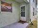 Charming condo front door with decorative wreath, 'Welcome Home' mat, and a cozy entrance at 1250 S Pinellas Ave # 207, Tarpon Springs, FL 34689
