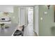 Hallway leading to a bathroom and kitchen with modern finishes and neutral tones at 1250 S Pinellas Ave # 207, Tarpon Springs, FL 34689
