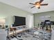 Inviting living room with modern furniture, a large flat-screen TV, and elegant decor at 1250 S Pinellas Ave # 207, Tarpon Springs, FL 34689