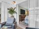 Cozy living room showcasing a comfortable chair and view into the light and airy bedroom at 1250 S Pinellas Ave # 207, Tarpon Springs, FL 34689