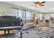 Open-concept living room featuring a piano, comfortable seating, and stylish decor at 1250 S Pinellas Ave # 207, Tarpon Springs, FL 34689