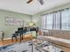 Elegant living room with piano, sofa, stylish rug, and bright natural light at 1250 S Pinellas Ave # 207, Tarpon Springs, FL 34689