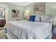 Spacious main bedroom showcasing a plush bed with decorative pillows and artwork at 1250 S Pinellas Ave # 207, Tarpon Springs, FL 34689
